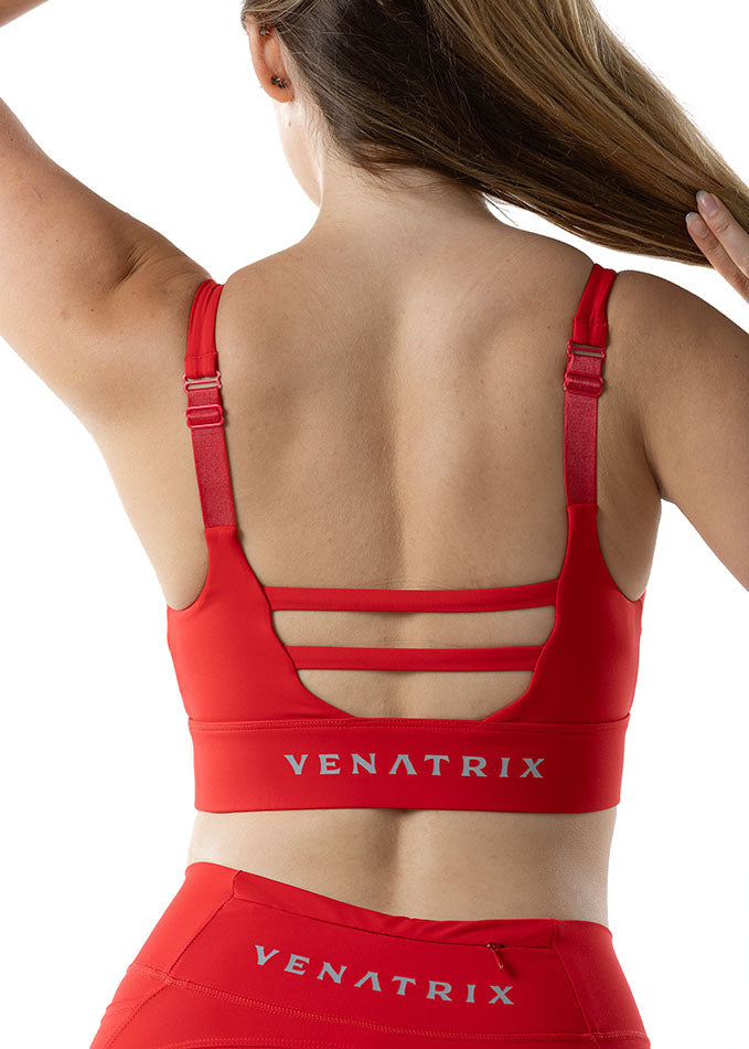 
                  
                    Red Venatrix sports bra back view with racerback design and adjustable straps for optimal workout support.
                  
                