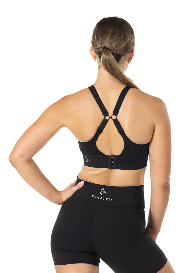 
                  
                    Back view of black Venatrix Performance racerback sports bra with adjustable clip closure for customizable fit.
                  
                